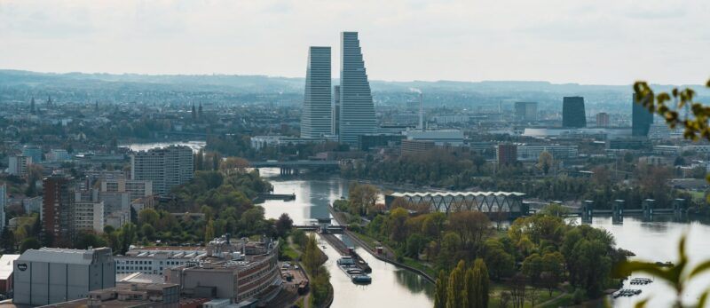 Basel Tourismus image showing the river rhine in Basel Switzerland and the Roche towers in the center of the image